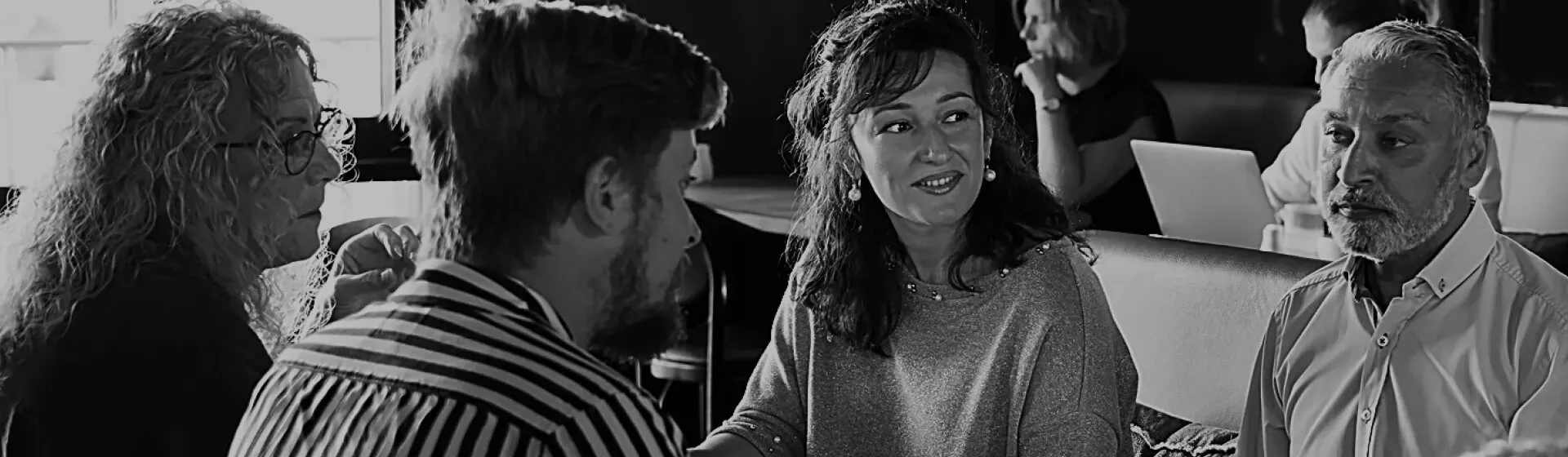 Male customer interacting with female server at the bar in a restaurant.